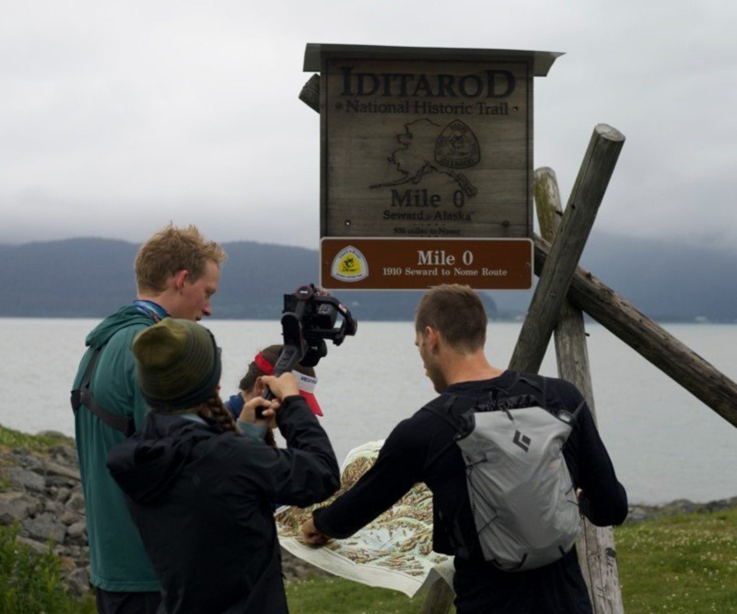 Eve Van Dommelen films Max Romey, Lars Arneson, and Denali Strabel just before they start the Southern Trek journey at Mile 0 of the Iditarod National Historic Trail (INHT) in Seward.