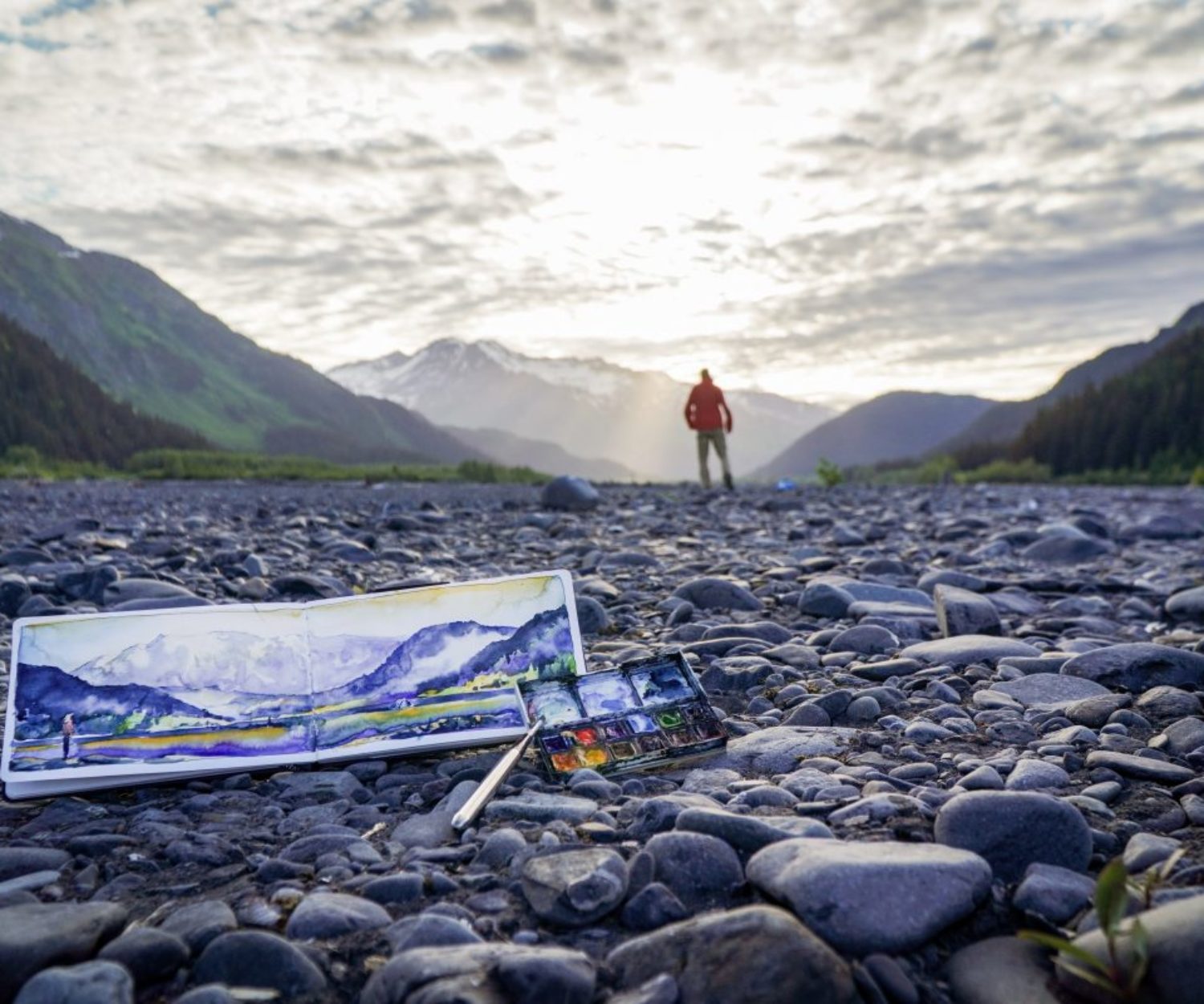 Max Romey watches as the sun begins to set in Seward, sharing a glimpse of the watercolor scene he just created.