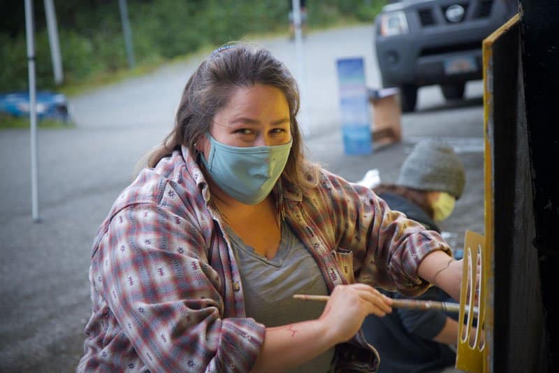 Melissa Shaginoff works on the Youth work on the Land Acknowledgement Mural in Girdwood