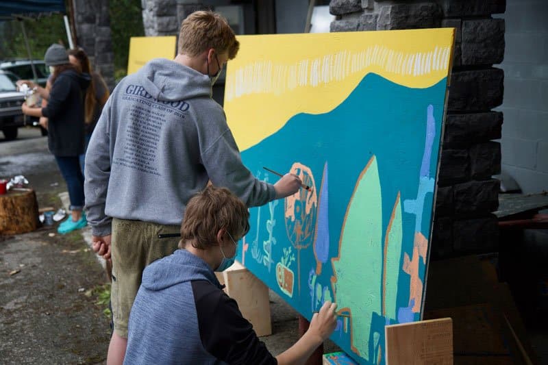 Youth work on the Land Acknowledgement Mural in Girdwood